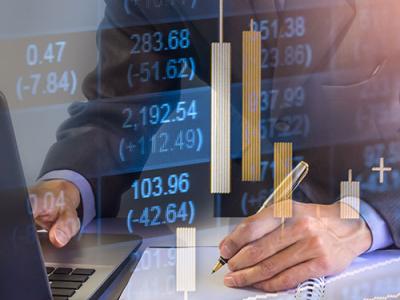 Man working at desk with graph overlay