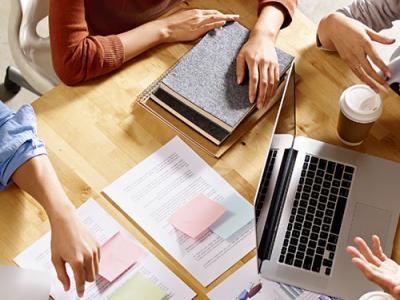 Closeup of practitioners working on desk